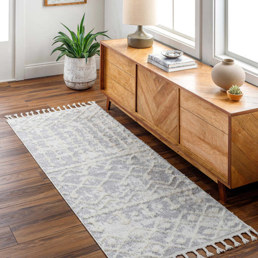 Living room scene with a gray and cream Dolo Area Rug, wood floors, and a mid-century modern console table. Roomscene-Runner