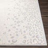 Close-up of the Delphia Cheetah Print Area Rug; gray and oatmeal animal print on a textured polypropylene rug. Front