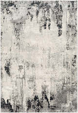 Close-up of the Dumangas Area Rug, a contemporary rug in black, charcoal, cream, and gray with an abstract pattern. Design-Rectangle-5373