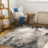 Living room scene with a black, gray, and cream Dumangas Area Rug, butterfly chair, and wood accents. Roomscene-Rectangle