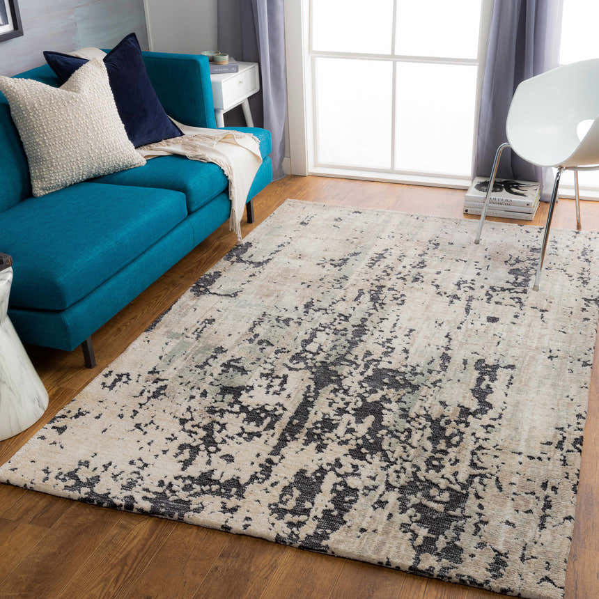 Living room scene with a Dundry Area Carpet in charcoal and cream, blue sofa, and wood floors. Roomscene-Rectangle