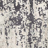 Close-up of the Dundry Area Carpet, a hand-woven rug in charcoal, cream, and light beige with a contemporary abstract design. Swatch