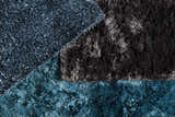 Close-up of the Auxier Area Rug showing its shag texture and ink blue, teal, and black colors. Styleshot