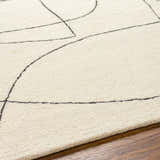 Close-up of Deniz Modern Off-White Wool Rug showing its textured wool and abstract gray line design on a wood floor. Texture