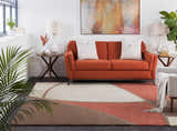 Living room scene with a rust sofa and Docena Carpet in beige, brown, and rust geometric design. Roomscene-Rectangle