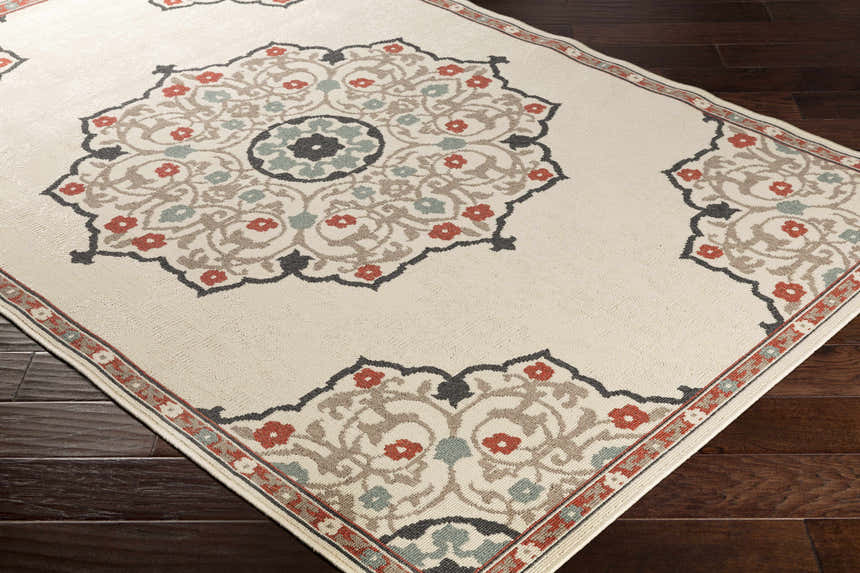 Close-up of the Dolomite Carpet showing its beige background and traditional brown, rust, and black floral medallion pattern. Corner