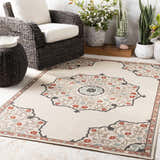 Outdoor patio scene with a beige Dolomite Carpet, wicker furniture, and potted plants. Roomscene-Rectangle