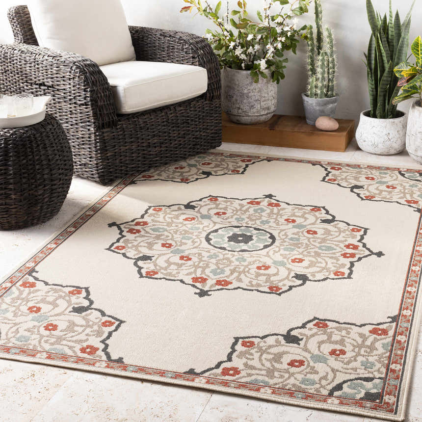 Outdoor patio scene with a beige Dolomite Carpet, wicker furniture, and potted plants. Roomscene-Rectangle