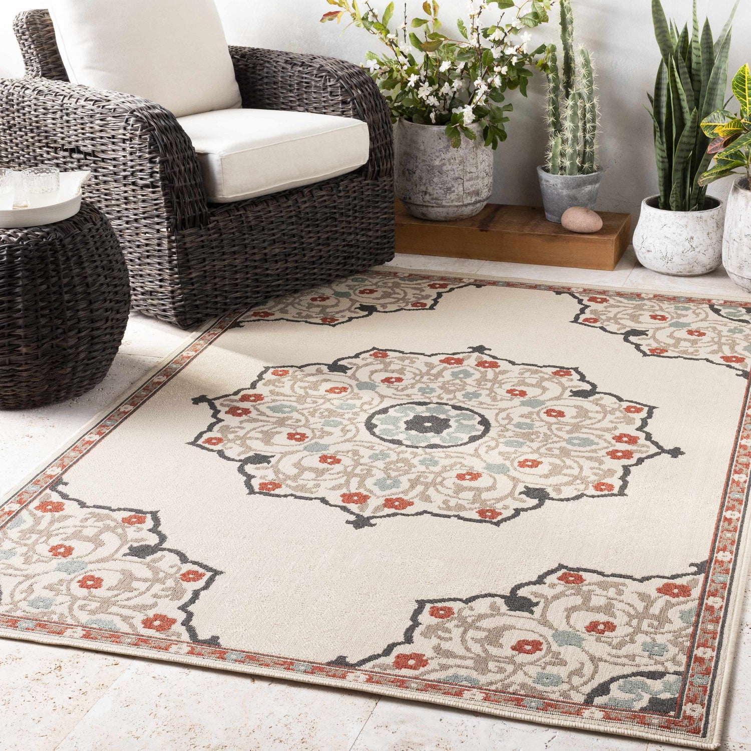 Outdoor patio scene with a beige Dolomite Carpet, wicker furniture, and potted plants. Roomscene-Rectangle