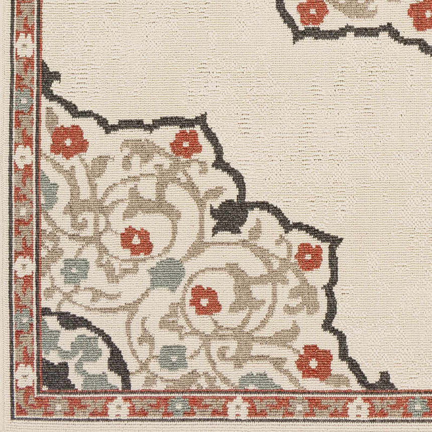 Close-up of Dolomite Carpet showing beige background, floral pattern with rust, sage, brown and black accents. Swatch