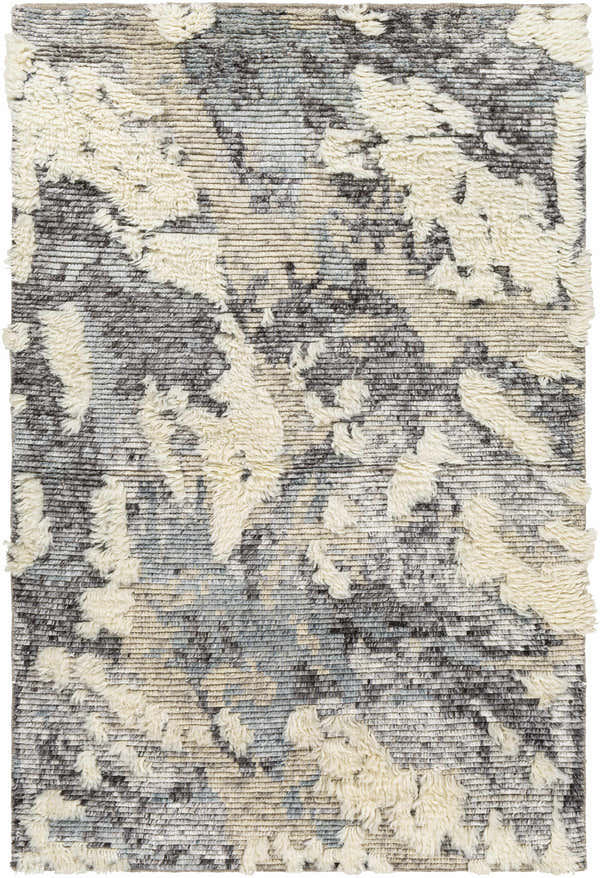Close-up of the Doveton Plush Wool Rug. Features a cream shag design on a gray, black, and blue hand-knotted wool base. Design-Rectangle-576
