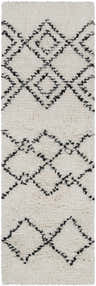 Close-up of the Dukedom Area Rug. Ivory shag rug with black geometric diamond pattern, hand woven wool texture. Design-Runner-268
