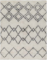 Close up of the hand woven Dukedom Area Rug, a shag rug with black geometric diamonds on ivory wool. Design-Rectangle-576