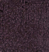 Close-up of the hand woven Duncanville Area Carpet. Plum colored 100% wool with a textured, looped design. Texture