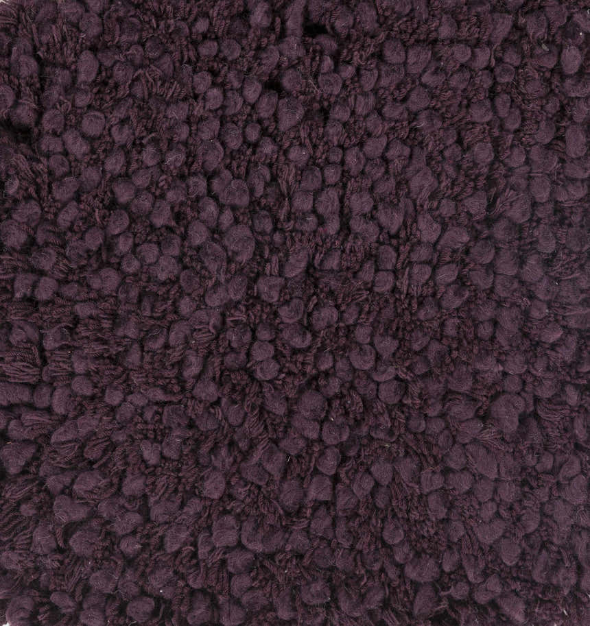 Close-up of the hand woven Duncanville Area Carpet. Plum colored 100% wool with a textured, looped design. Texture