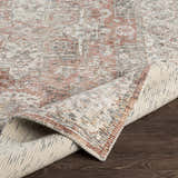Close-up of the hand-knotted Dunmor Area Rug showing brick red, charcoal, and cream colors with a traditional Persian pattern. Fold