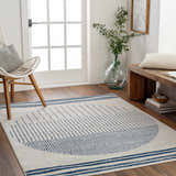 Entryway with a Duri Area Rug in admiral blue and natural gray, styled with a bench and chair. Roomscene-Rectangle