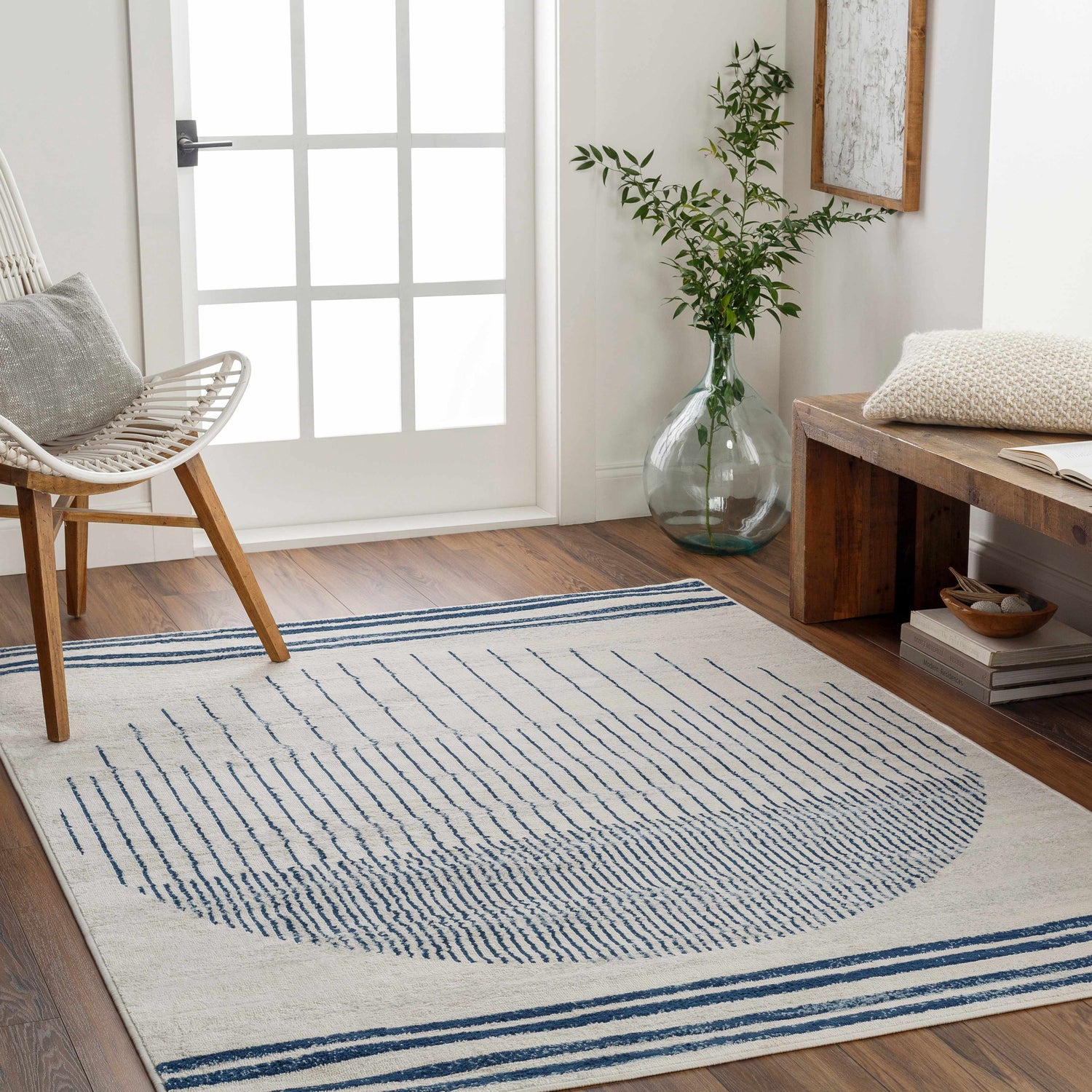 Entryway with a Duri Area Rug in admiral blue and natural gray, styled with a bench and chair. Roomscene-Rectangle