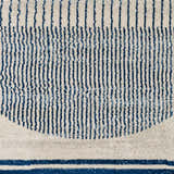 Close-up of the Duri Area Rug, featuring a geometric pattern with admiral blue stripes on a natural gray background. Swatch