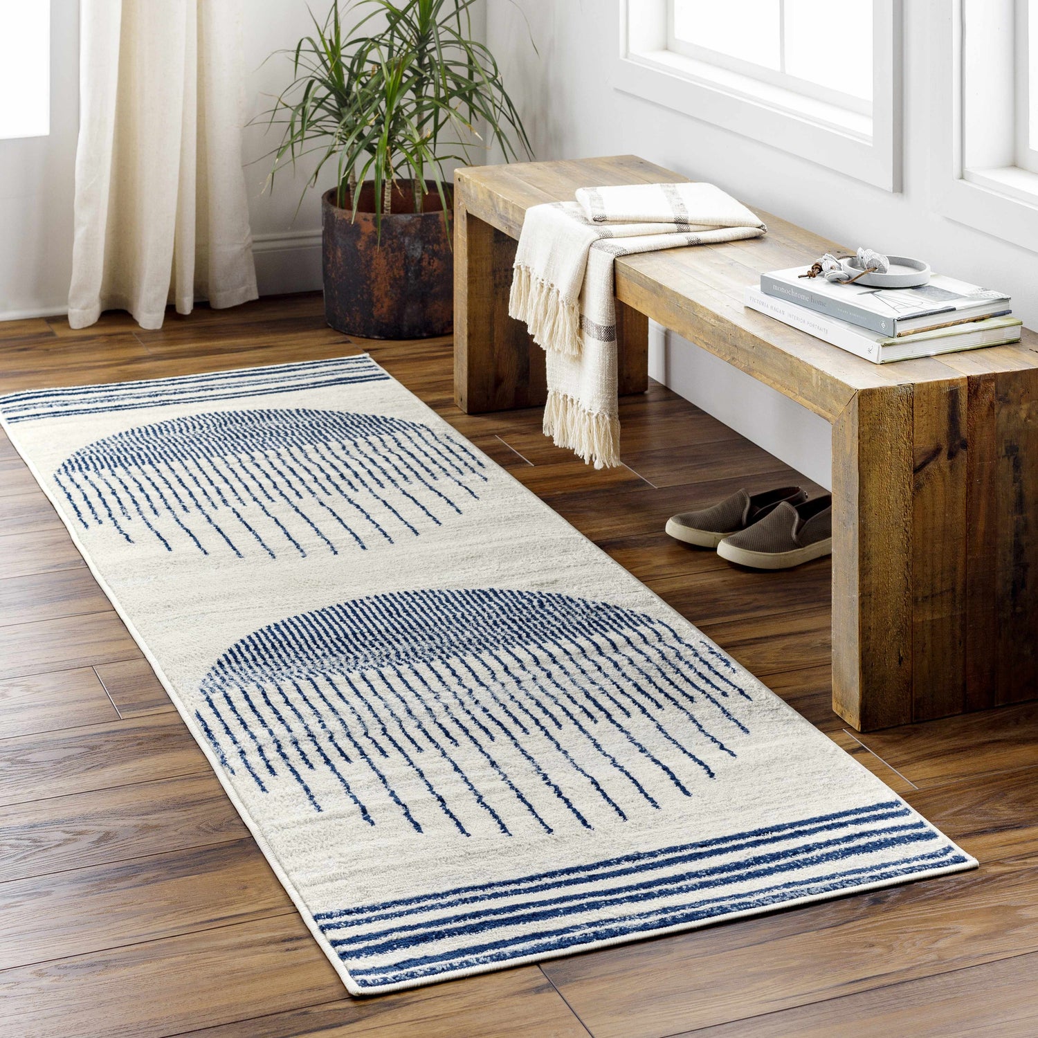 Entryway styled with a Duri Area Rug. The runner rug has a geometric blue pattern on a natural background. Roomscene-Runner