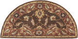 Close-up of the Hearth-shaped Daviston Area Rug. Brown wool rug with brick red, beige, and floral pattern. Design-Hearth