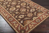 Close-up of the hand-tufted Daviston Area Rug. Features a traditional floral pattern in beige, brown, and brick red tones. Corner