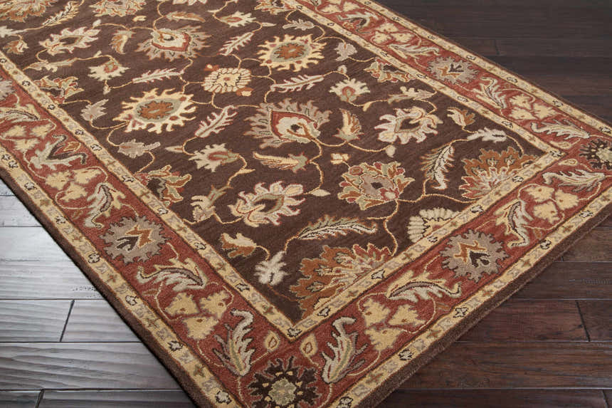 Close-up of the hand-tufted Daviston Area Rug. Features a traditional floral pattern in beige, brown, and brick red tones. Corner