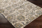 Close-up of the Morinville Teal Floral Rug, showcasing its brown, teal, and mustard floral pattern on dark wood floors. Corner