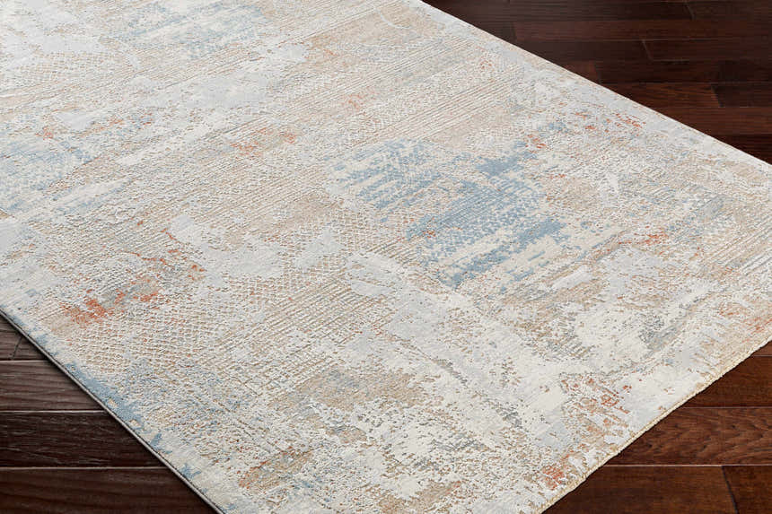 Close-up of the Efren Thick Luxe Area Rug showing its dark beige, dusty sage, and gray contemporary design. Corner