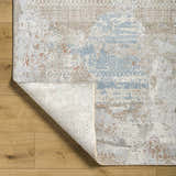 Close-up of the Efren Thick Luxe Area Rug showing its abstract design, dark beige, dusty sage, and gray colors. Fold