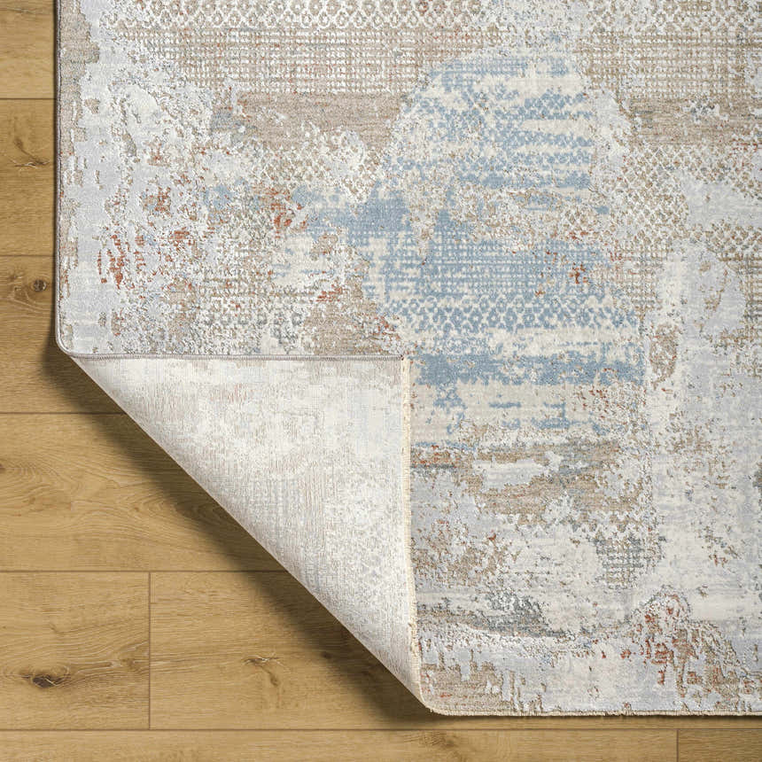 Close-up of the Efren Thick Luxe Area Rug showing its abstract design, dark beige, dusty sage, and gray colors. Fold