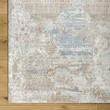 Close-up of the Efren Thick Luxe Area Rug showing its dark beige, dusty sage, and gray contemporary pattern. Corner