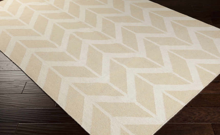 Close-up of the Elamton Area Rug, a hand-woven wool rug with a contemporary geometric pattern in beige and cream. Corner
