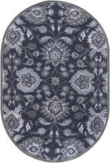 Close-up of the oval Conesus Hand Tufted Blue Area Rug. Features a traditional floral pattern in charcoal, denim, and slate blue. Design-Oval-69