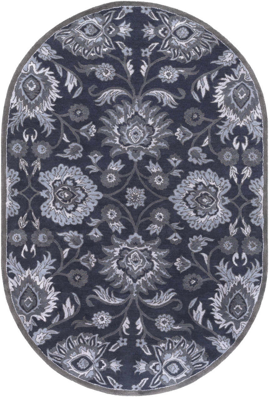 Close-up of the oval Conesus Hand Tufted Blue Area Rug. Features a traditional floral pattern in charcoal, denim, and slate blue. Design-Oval-69