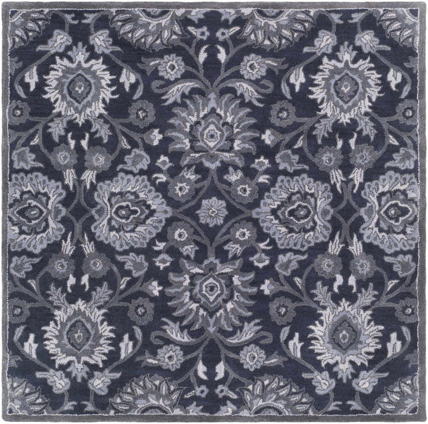 Close up of the Conesus Hand Tufted Blue Area Rug with a traditional floral pattern in charcoal, denim, and slate blue. Design-Square-6