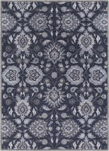 Close-up of the Conesus Hand Tufted Blue Area Rug, featuring a traditional floral pattern in denim, slate, and charcoal hues. Design-Rectangle-811