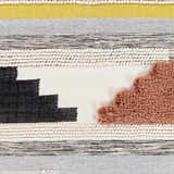 Close-up of the Elsenham Area Rug. Hand-woven cotton rug with black, cream, mustard, gray and brick red colors. Bohemian style. Swatch