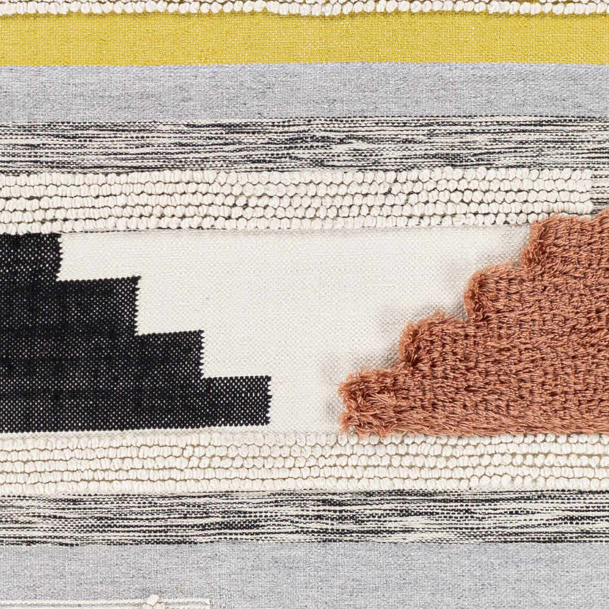 Close-up of the Elsenham Area Rug. Hand-woven cotton rug with black, cream, mustard, gray and brick red colors. Bohemian style. Swatch