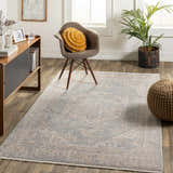 Living room scene with a light blue Tusa Blue Area Rug, wood floors, chair, cabinet, and plant. Roomscene-Rectangle