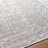 Close-up of the Epson Indoor & Outdoor Rug with a geometric pattern in blue, gray, and oatmeal. Machine woven texture. Texture