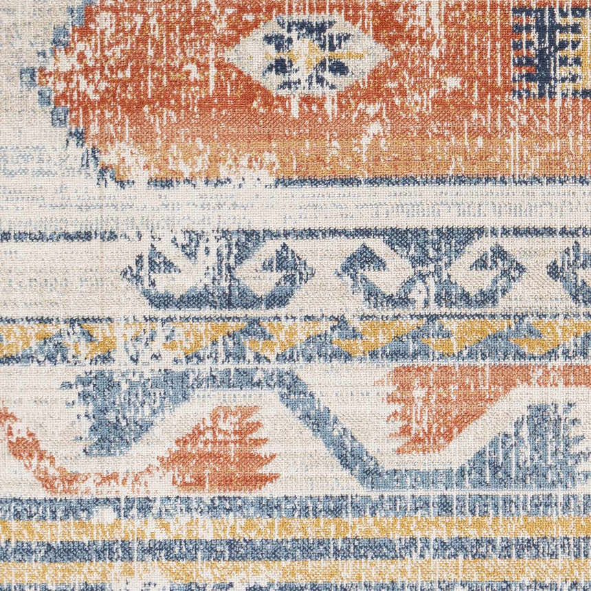 Close-up of the Etobicoke Area Rug. Features a traditional Southwestern pattern in brick red, cream, denim, and tan. Swatch