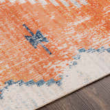 Close-up of the Etobicoke Area Rug showing brick red, cream, and denim hues in a Southwestern-inspired pattern. Texture