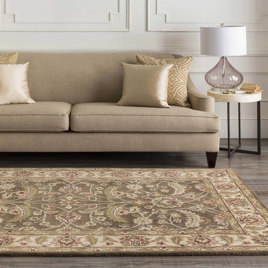 Living room scene with a beige sofa and the brown floral Eupora Wool Rug. Roomscene-Rectangle