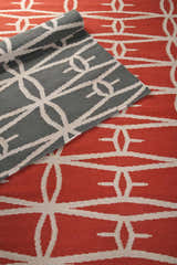 Close-up of the hand-woven Lipan Area Rug. Charcoal and peach wool rug with a contemporary geometric pattern. Styleshot