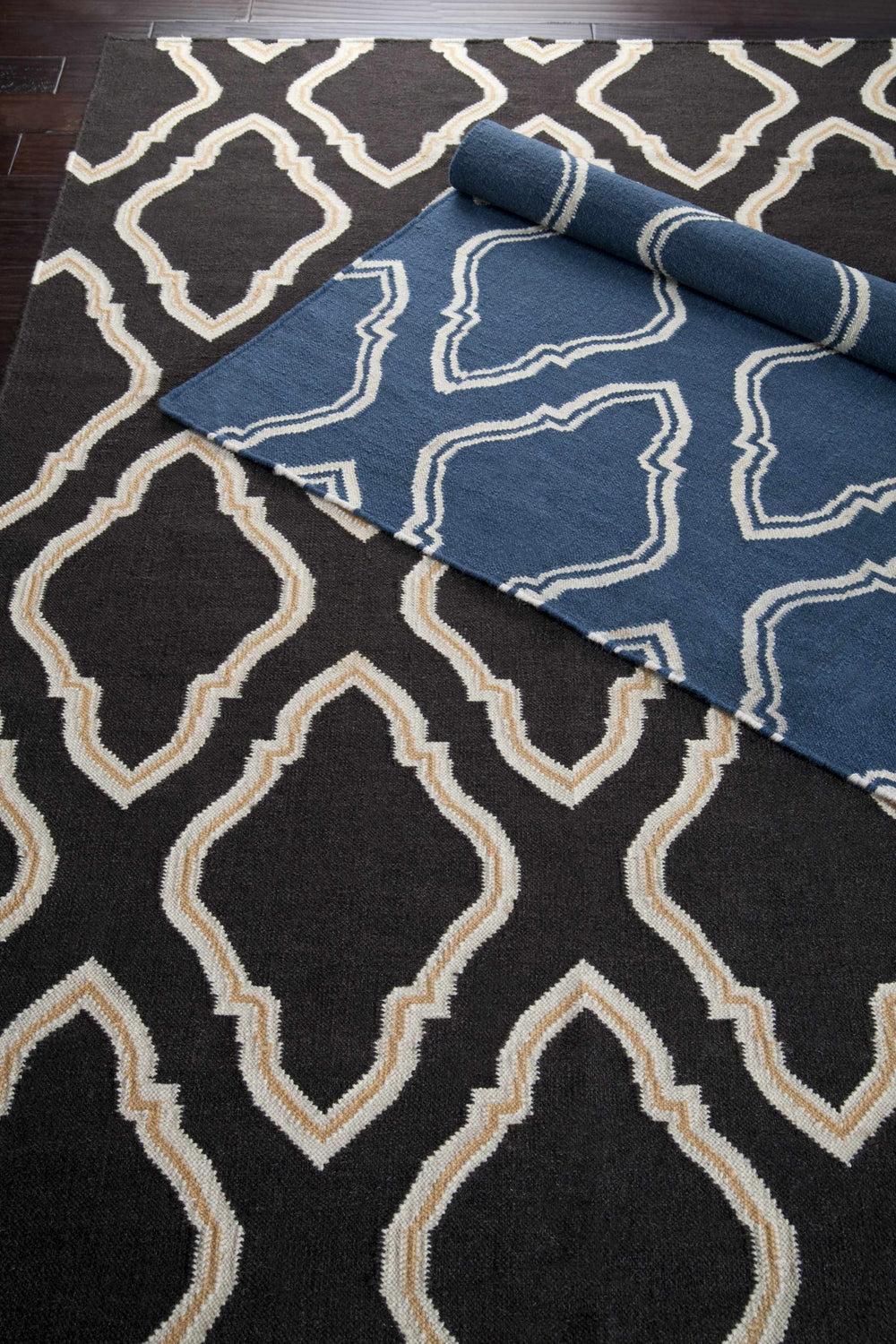 Close-up of the Anchorage Area Carpet in dark blue and cream, featuring a hand-woven geometric pattern. Styleshot