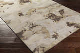 Close up of Faubush area rug showing abstract dark brown, light brown, and gray pattern on a wool rug with dark wood floors. Corner
