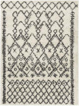 Close-up of the Fenstanton Area Rug, a cream shag rug with a charcoal geometric diamond pattern. Design-Rectangle-527