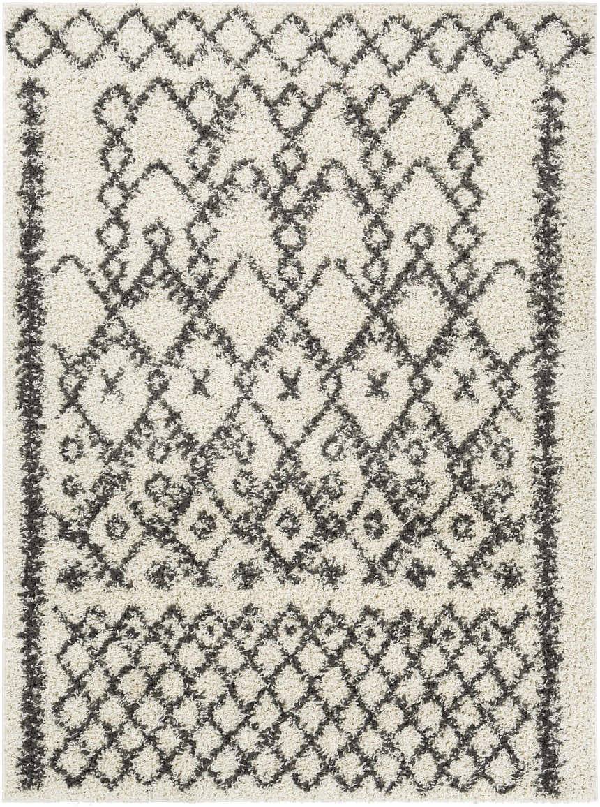 Close-up of the Fenstanton Area Rug, a cream shag rug with a charcoal geometric diamond pattern. Design-Rectangle-527