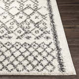 Close up of the charcoal and cream Fenstanton Area Rug, a shag rug with a geometric pattern. Front